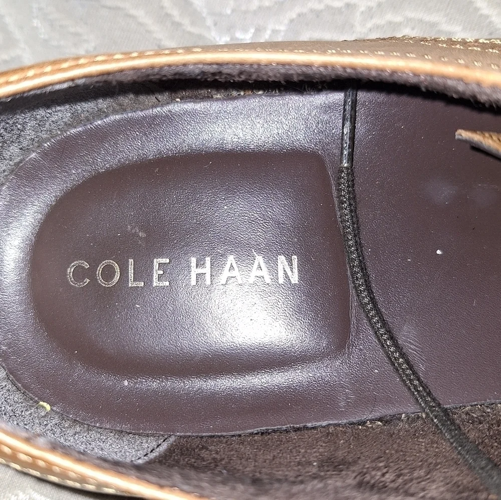 A pair of Cole Haan Oxfords in a men's size 12M. Pre-loved in good condition.